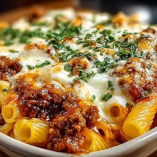 Baked ziti with ground beef and ricotta topped with melted cheese