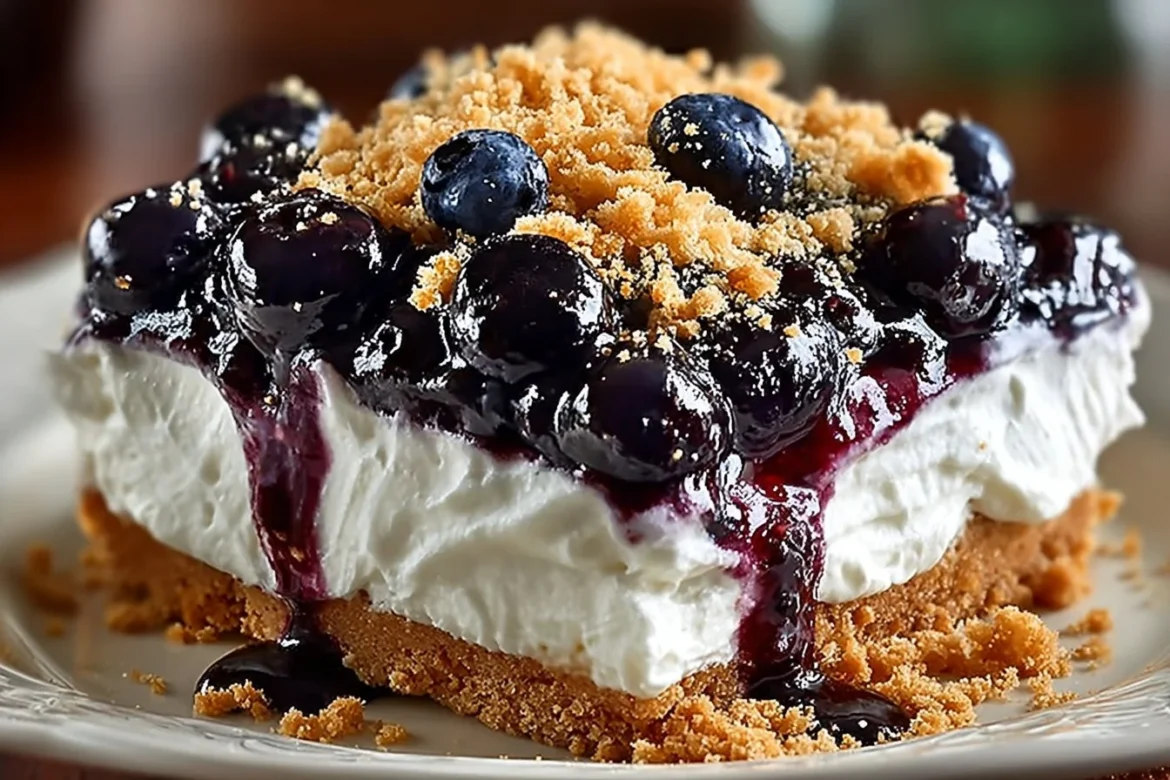 Delicious no-bake blueberry dessert served in a glass dish with fresh blueberries on top.