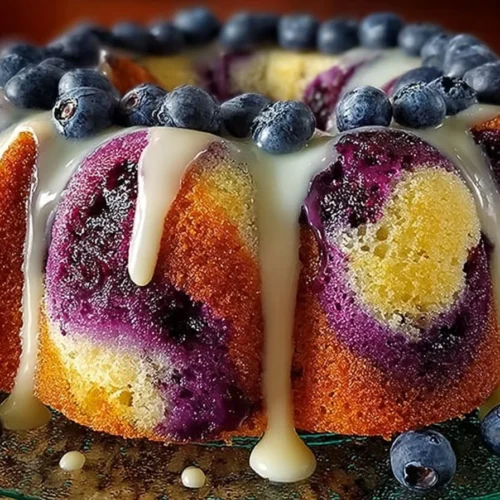 Delicious classic blueberry pound cake with sour cream topping and blueberries