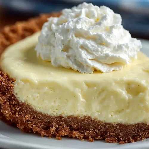Cream Cheese Lemonade Pie topped with whipped cream and lemon slices