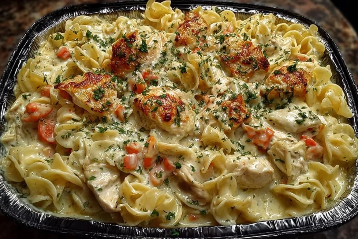 Creamy chicken noodle casserole served in a baking dish with vegetables