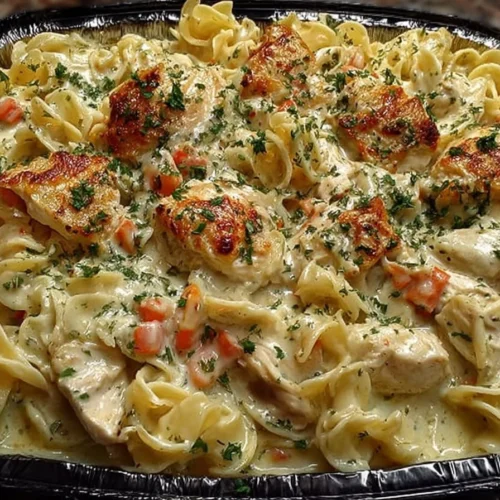 Creamy chicken noodle casserole served in a baking dish with vegetables