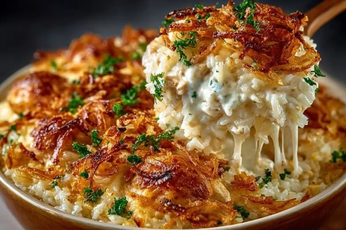 Delicious French onion chicken rice casserole baked in a dish, garnished with herbs.