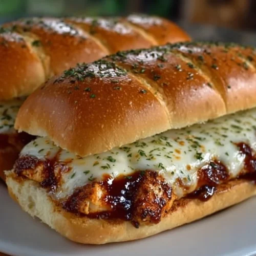 Grilled mozzarella BBQ chicken sandwich topped with fresh herbs