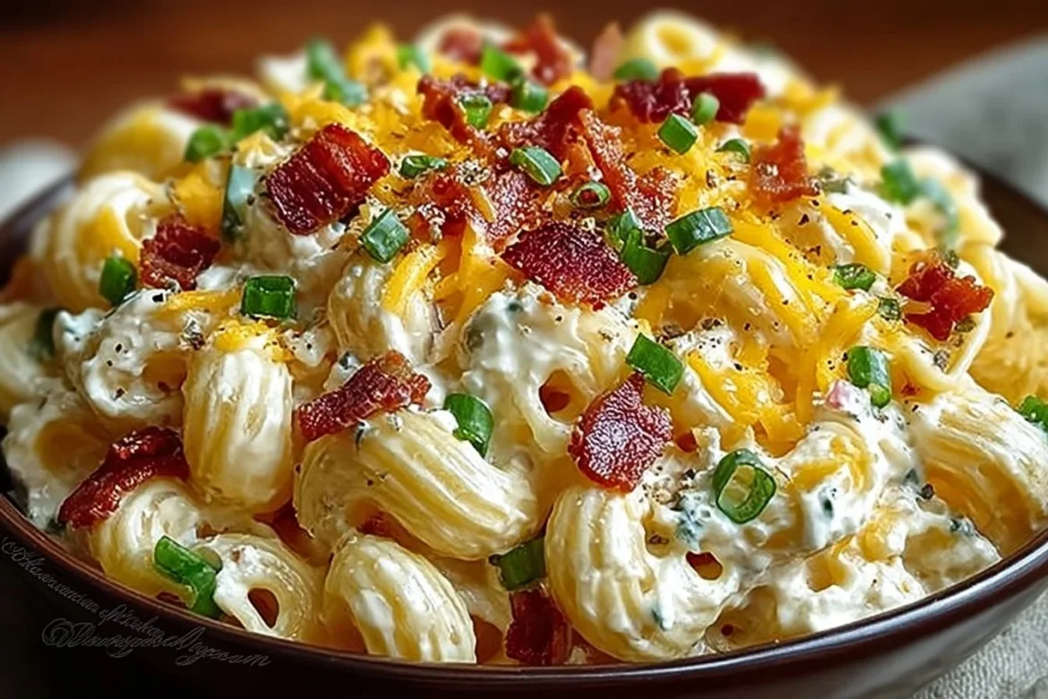 Bowl of jalapeño popper macaroni salad garnished with fresh herbs