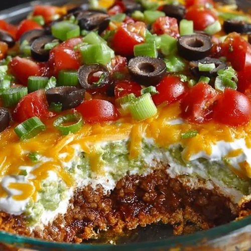 Delicious layered taco dip served in a colorful dish.