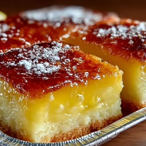 Delicious two-ingredient lemon bars topped with powdered sugar on a plate