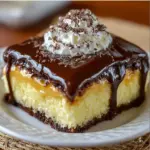 Delicious Boston Cream Poke Cake topped with chocolate and vanilla custard
