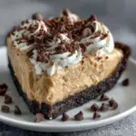 Delicious creamy peanut butter pie with chocolate crust on a plate