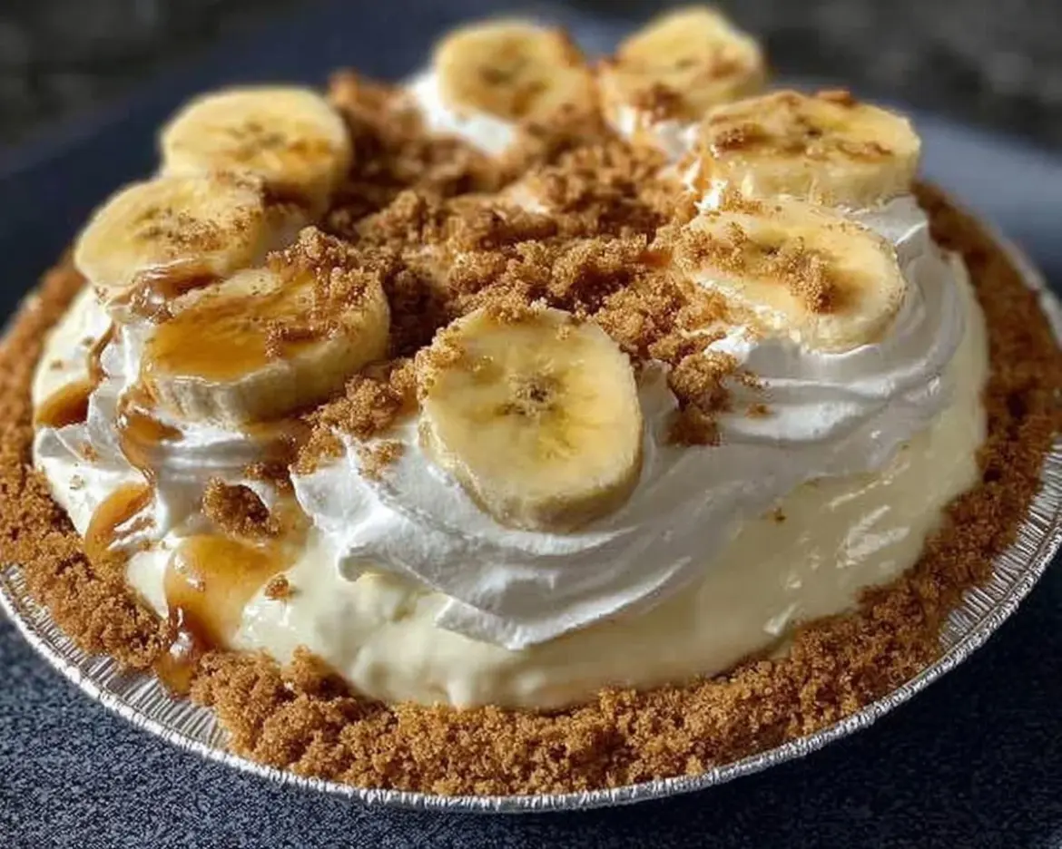Delicious easy banana cream pie topped with whipped cream and banana slices