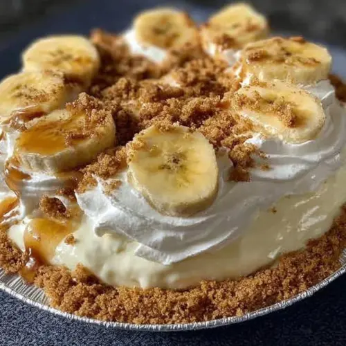 Delicious easy banana cream pie topped with whipped cream and banana slices