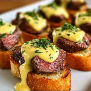 Grilled tenderloin crostini garnished with béarnaise sauce.