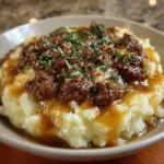 Delicious ground beef and gravy served over creamy mashed potatoes.