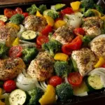Healthy roasted chicken served with a variety of colorful veggies