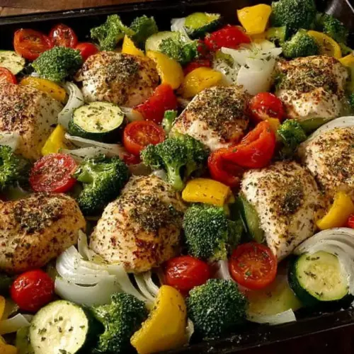 Healthy roasted chicken served with a variety of colorful veggies