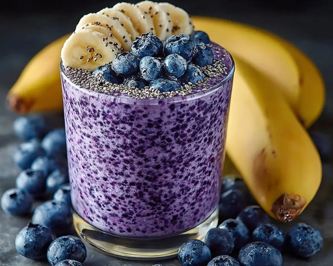 Delicious Banana-Blueberry Smoothie in a glass with fresh fruit toppings