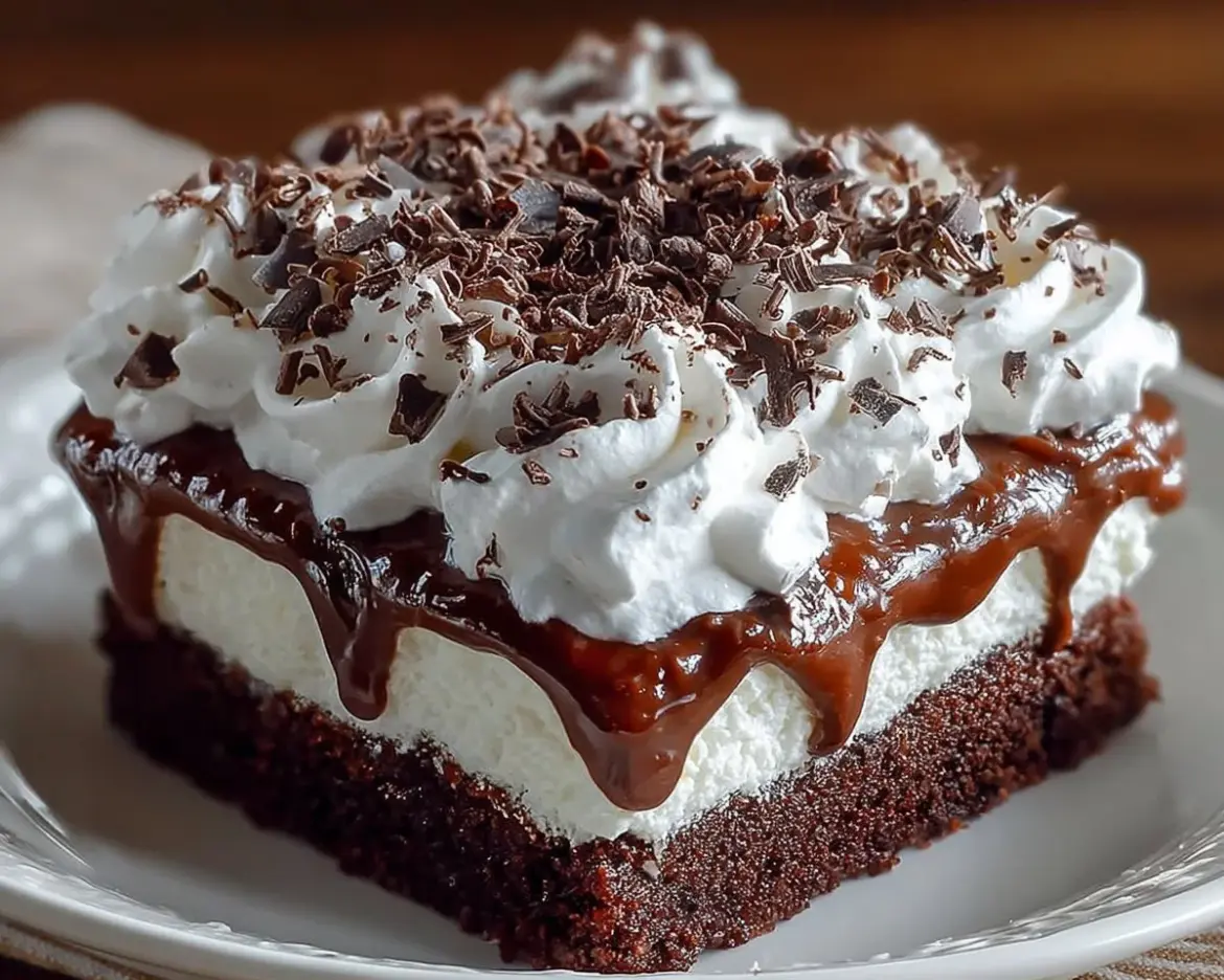 Delicious Brownie Refrigerator Cake topped with chocolate ganache and nuts