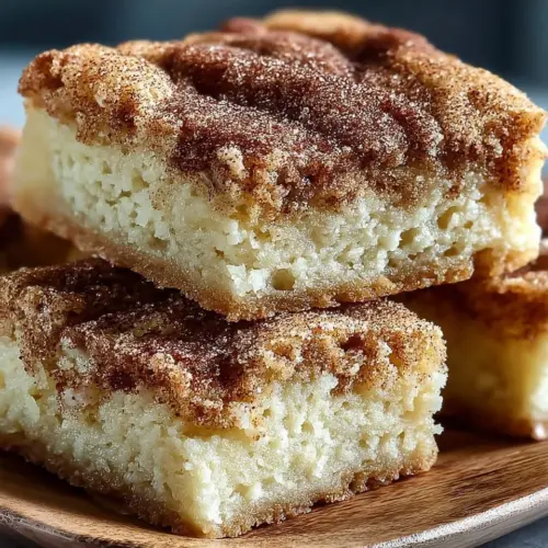 Chewy snickerdoodle cookie bars with cinnamon sugar topping