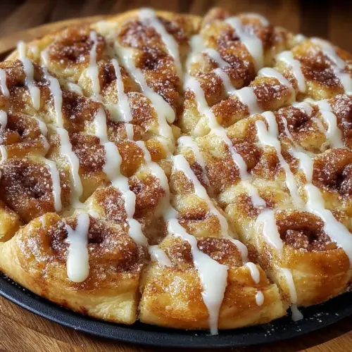 Cinnamon-sugar pizza made with crescent rolls, topped with sweet cinnamon and sugar.