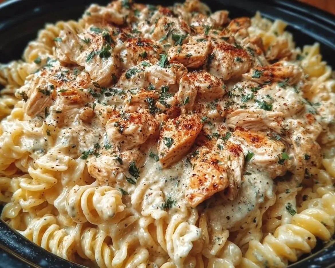 Crockpot Garlic Parmesan Chicken Pasta ready to serve in a bowl.