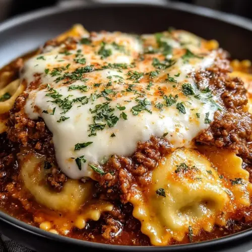 Crockpot Ravioli Lasagna topped with cheese and fresh herbs in a slow cooker