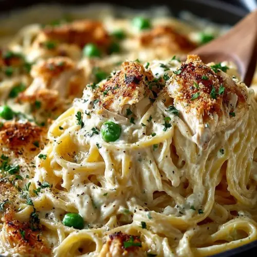 Delicious bowl of easy chicken tetrazzini topped with cheese and herbs