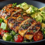 Delicious grilled chicken avocado salad with fresh vegetables and dressing