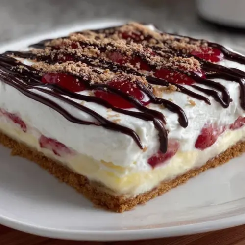 Layered banana split dessert with ice cream, fresh bananas, and toppings