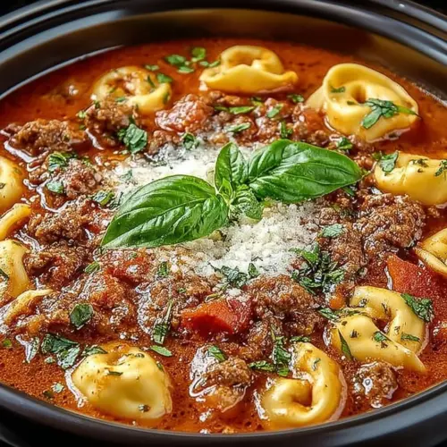 Bowl of slow cooker tomato tortellini soup with ground beef and herbs